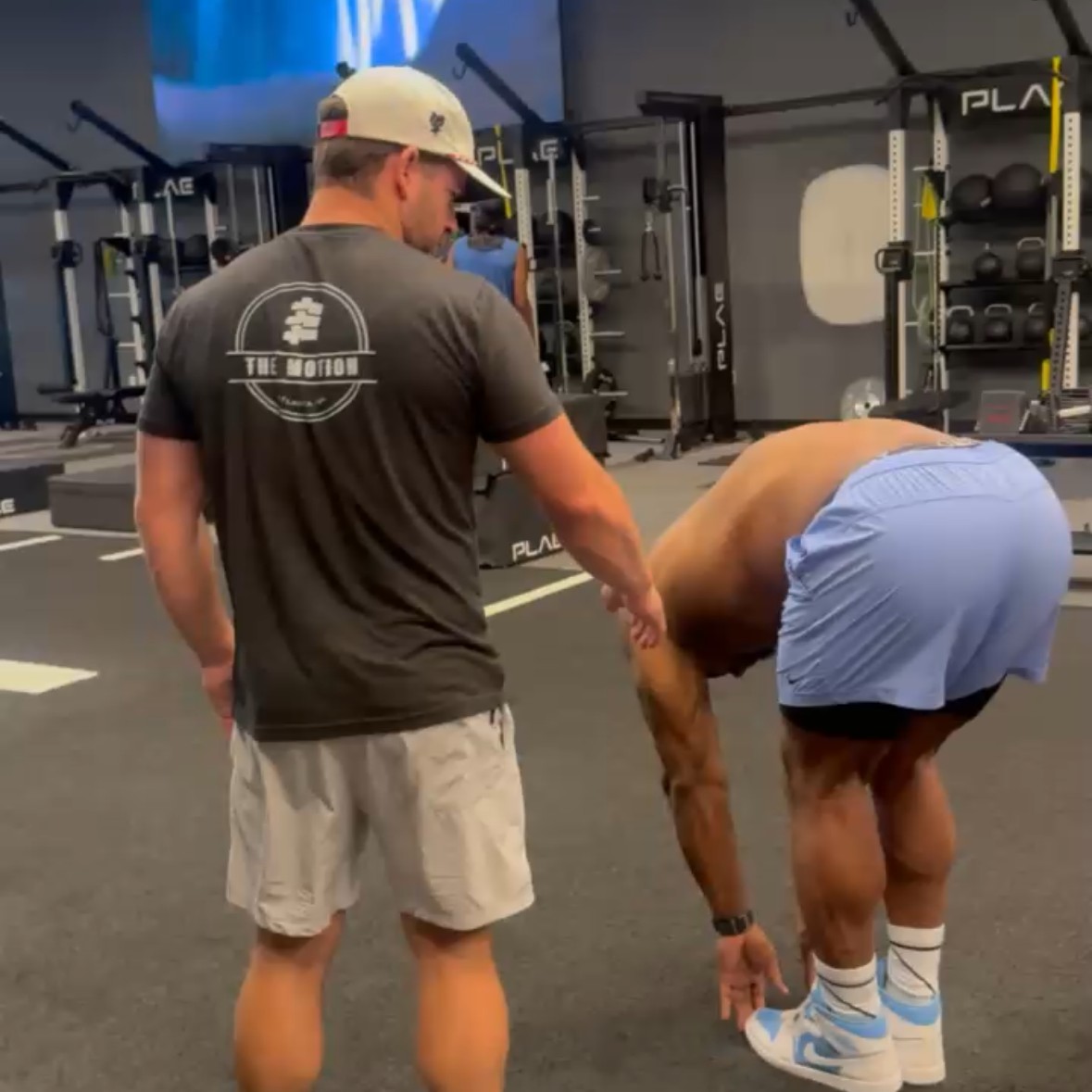 Coaching a mobility movement at The Motion training facility